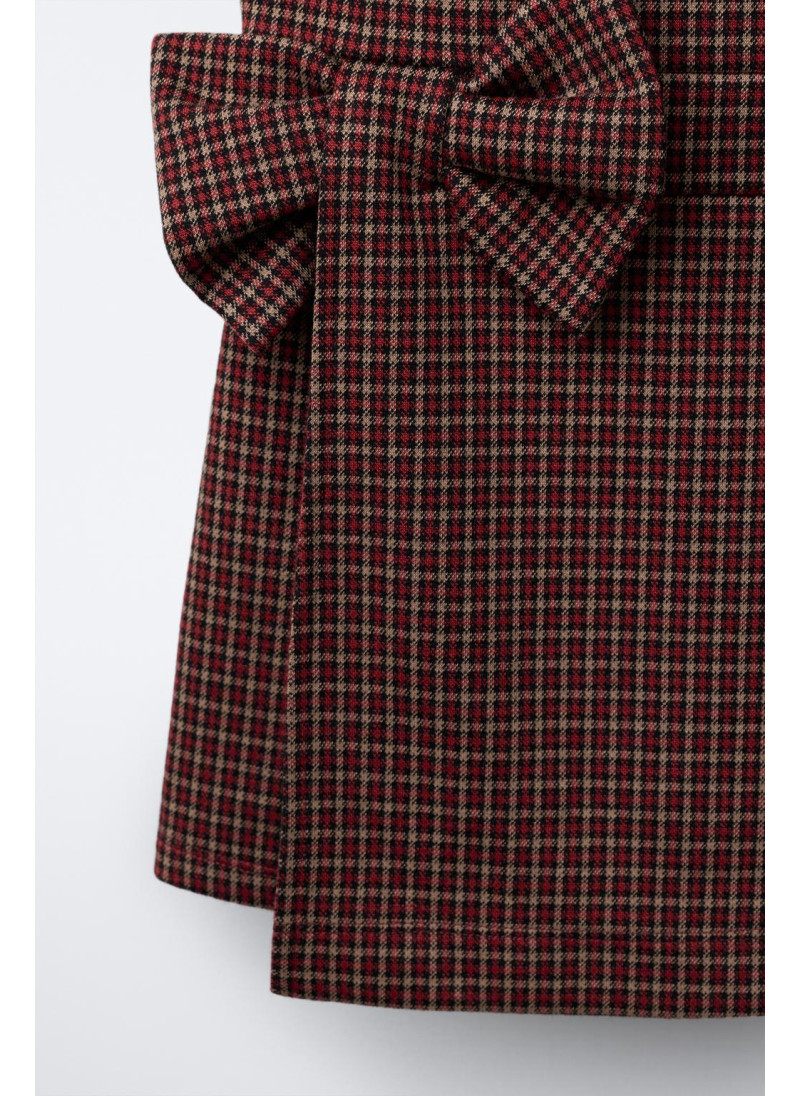 Шорты-комбинезон с клетчатым узелком Шорты-комбинезон с клетчатым узелком